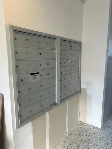 a utility room with stainless steel appliances wooden cabinet and a sink