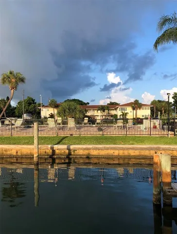 a view of swimming pool with outdoor seating and city view