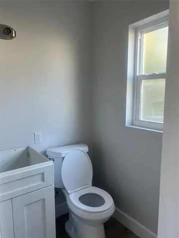 a white toilet sitting next to a window