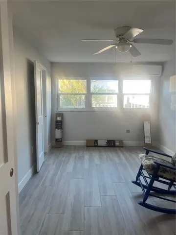 a view of a room with wooden floor and windows