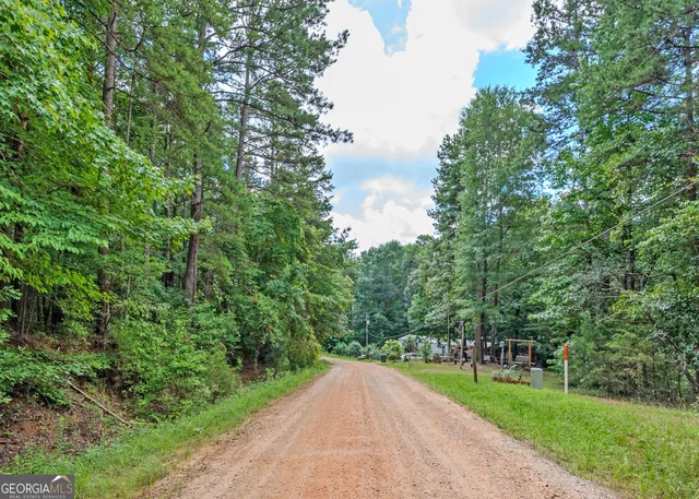 a view of a road with a yard and lake view