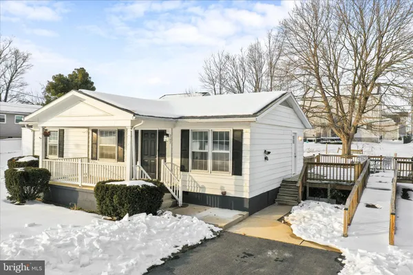 a view of a house with a yard covered in snow