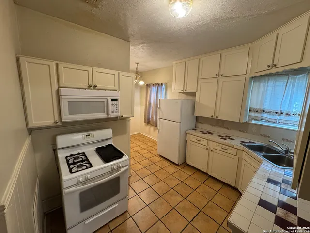 a kitchen with a refrigerator stove and sink