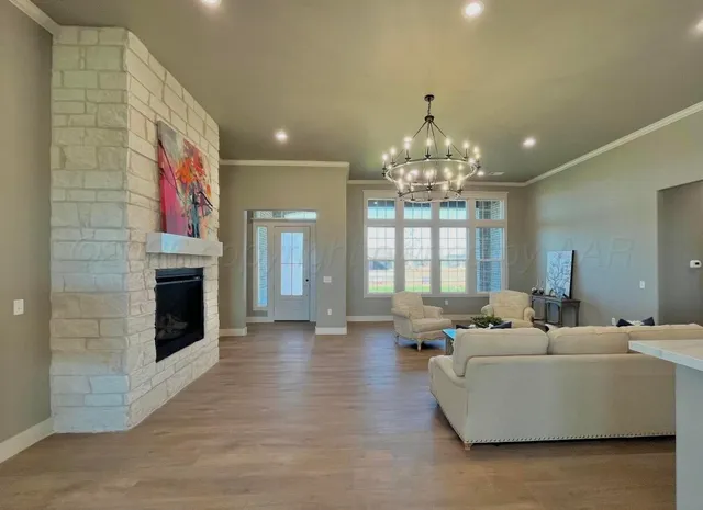a living room with furniture and a chandelier