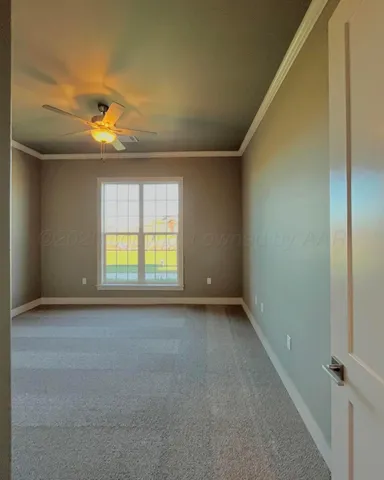 an empty room with a window and chandelier