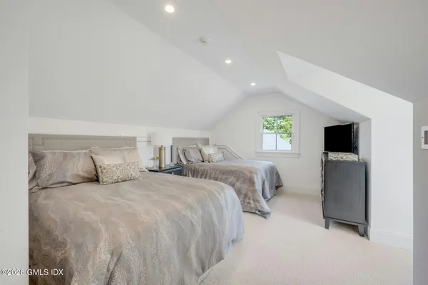 a bedroom with a bed and a night stand