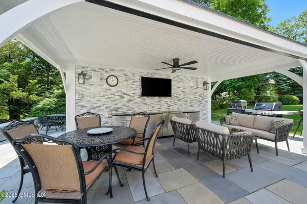 a view of a patio with table and chairs and potted plants