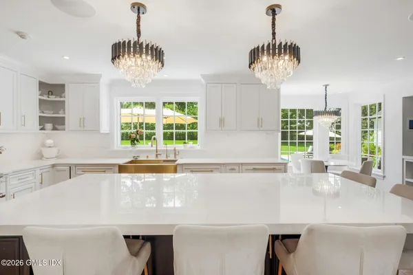 a kitchen with a table and a chandelier