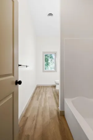 a bathroom with a bathtub and window