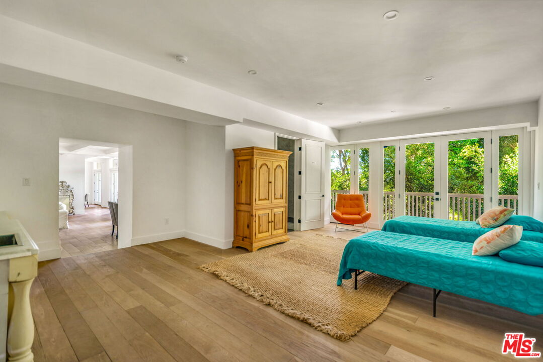 9669 Oak Pass Road Beverly Hills, CA 90210 - Photo 30 of 37 a living room with furniture and a window