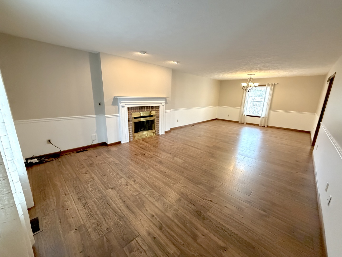 1867 Gragg Street Centralia, IL 62801 - Photo 5 of 30 an empty room with wooden floor and fireplace
