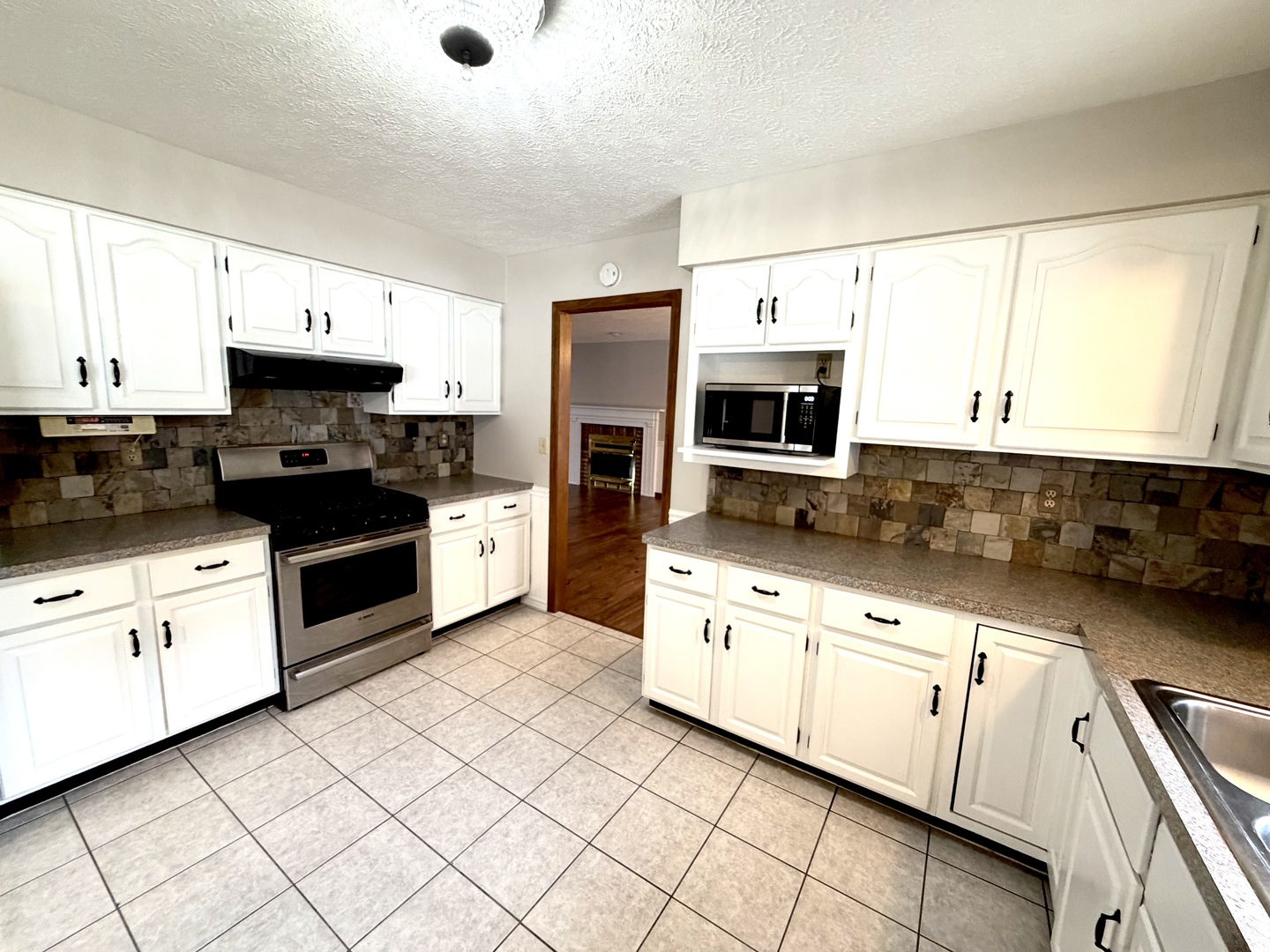 1867 Gragg Street Centralia, IL 62801 - Photo 6 of 30 a kitchen with granite countertop white cabinets and stainless steel appliances