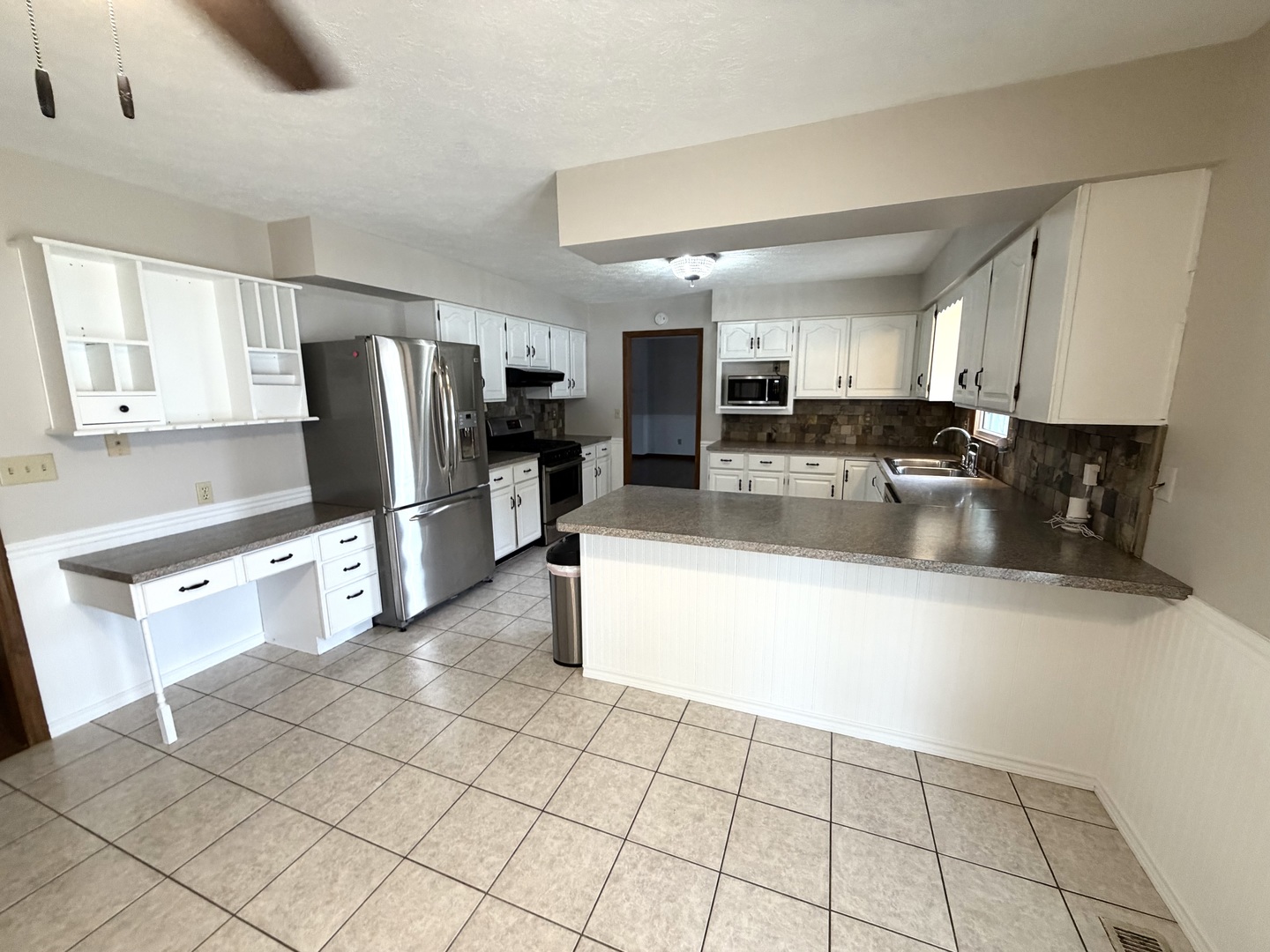 1867 Gragg Street Centralia, IL 62801 - Photo 7 of 30 a kitchen with stainless steel appliances granite countertop a refrigerator a stove a sink a microwave and island
