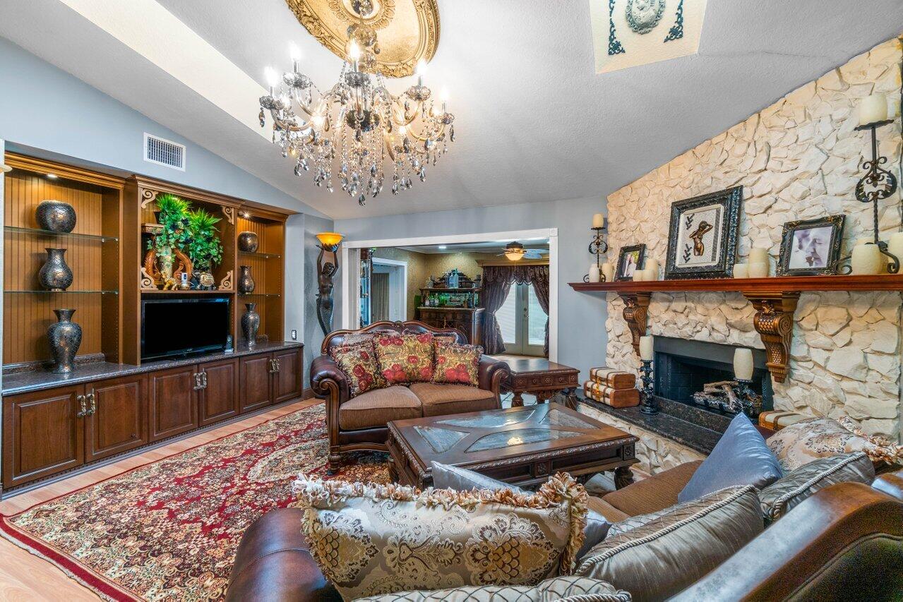 294 Northwest 69th Street Boca Raton, FL 33487 - Photo 12 of 39 a living room with furniture and a fireplace
