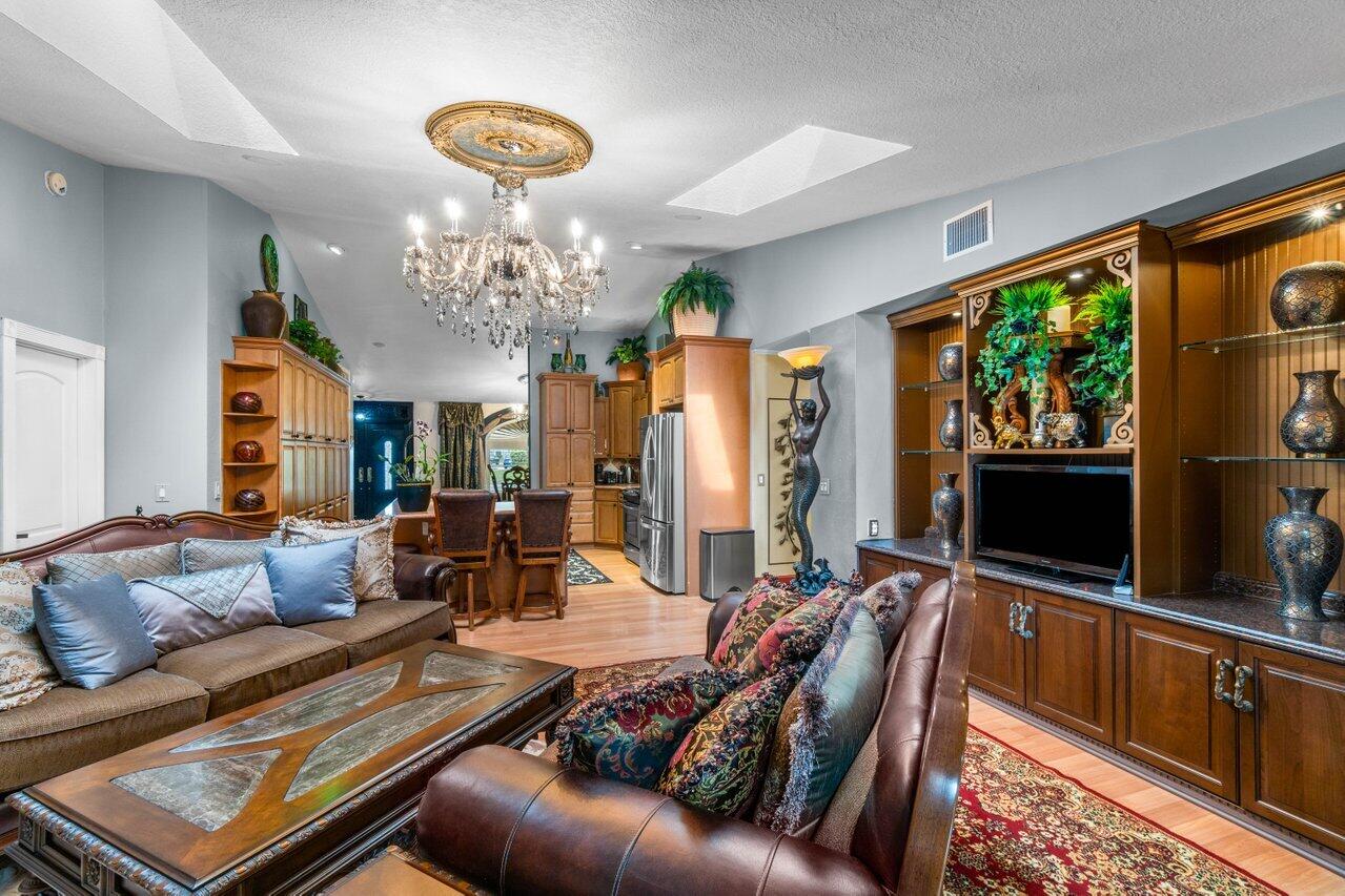 294 Northwest 69th Street Boca Raton, FL 33487 - Photo 13 of 39 a living room with furniture a flat screen tv and a large window