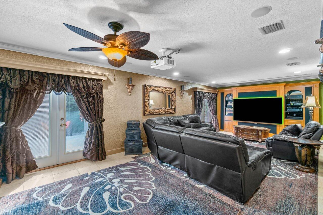 294 Northwest 69th Street Boca Raton, FL 33487 - Photo 14 of 39 a living room with furniture and a flat screen tv