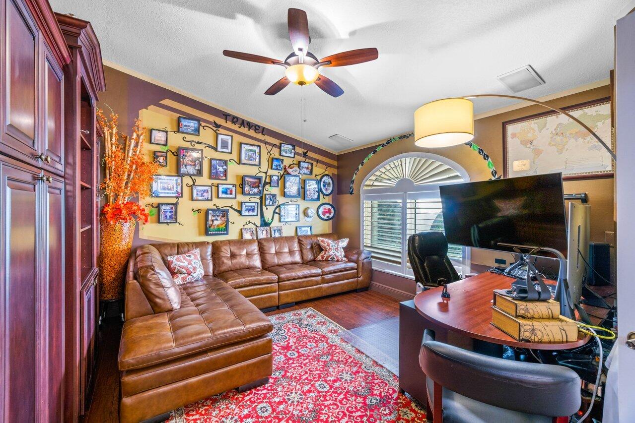 294 Northwest 69th Street Boca Raton, FL 33487 - Photo 17 of 39 a bedroom with furniture and a flat screen tv