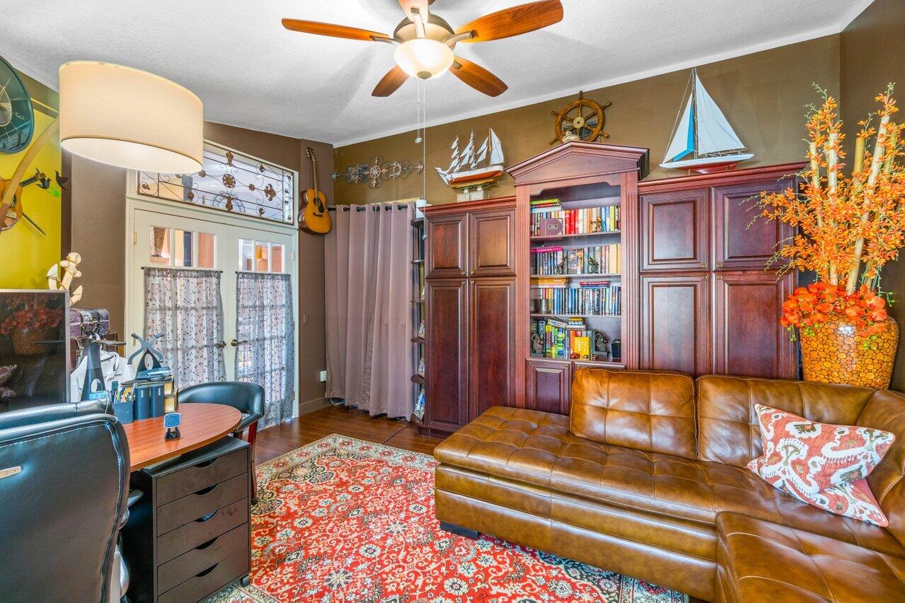 294 Northwest 69th Street Boca Raton, FL 33487 - Photo 18 of 39 a bedroom with a bed dresser and a window