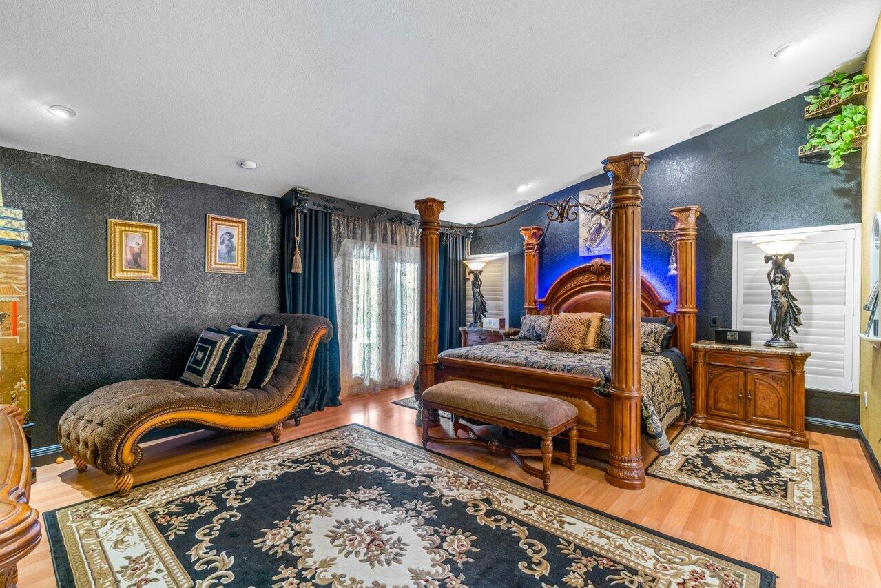 294 Northwest 69th Street Boca Raton, FL 33487 - Photo 19 of 39 a bedroom with furniture and a rug