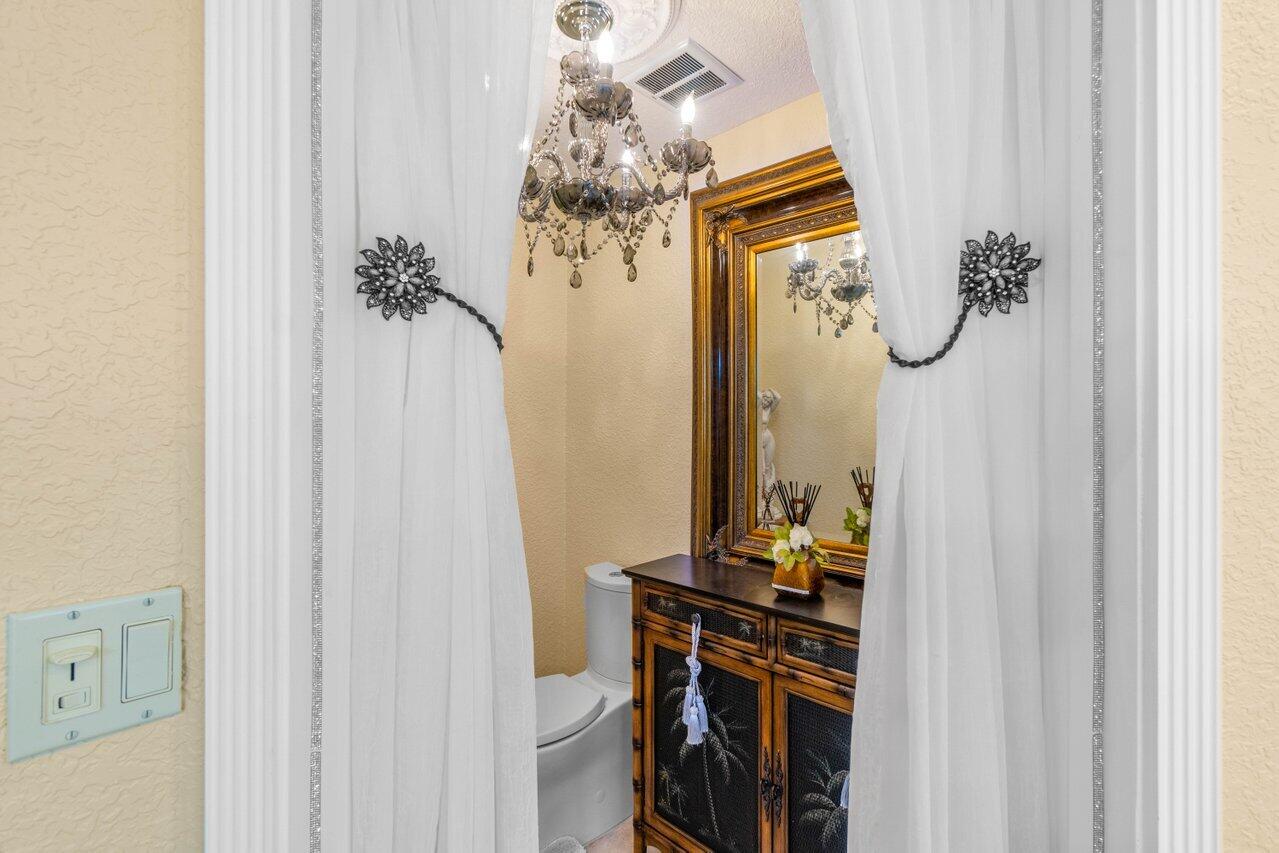 294 Northwest 69th Street Boca Raton, FL 33487 - Photo 23 of 39 a view of a hallway with mirror on the wall