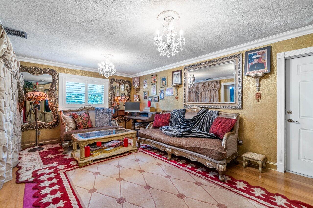 294 Northwest 69th Street Boca Raton, FL 33487 - Photo 28 of 39 a living room with furniture and a chandelier