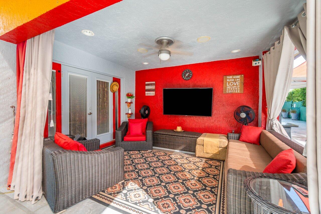294 Northwest 69th Street Boca Raton, FL 33487 - Photo 32 of 39 a living room with furniture and flat screen tv