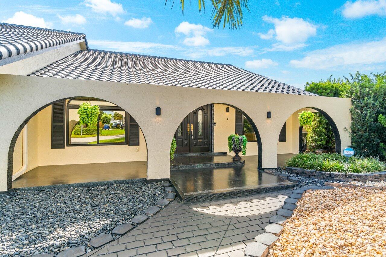 294 Northwest 69th Street Boca Raton, FL 33487 - Photo 4 of 39 a view of swimming pool with a patio