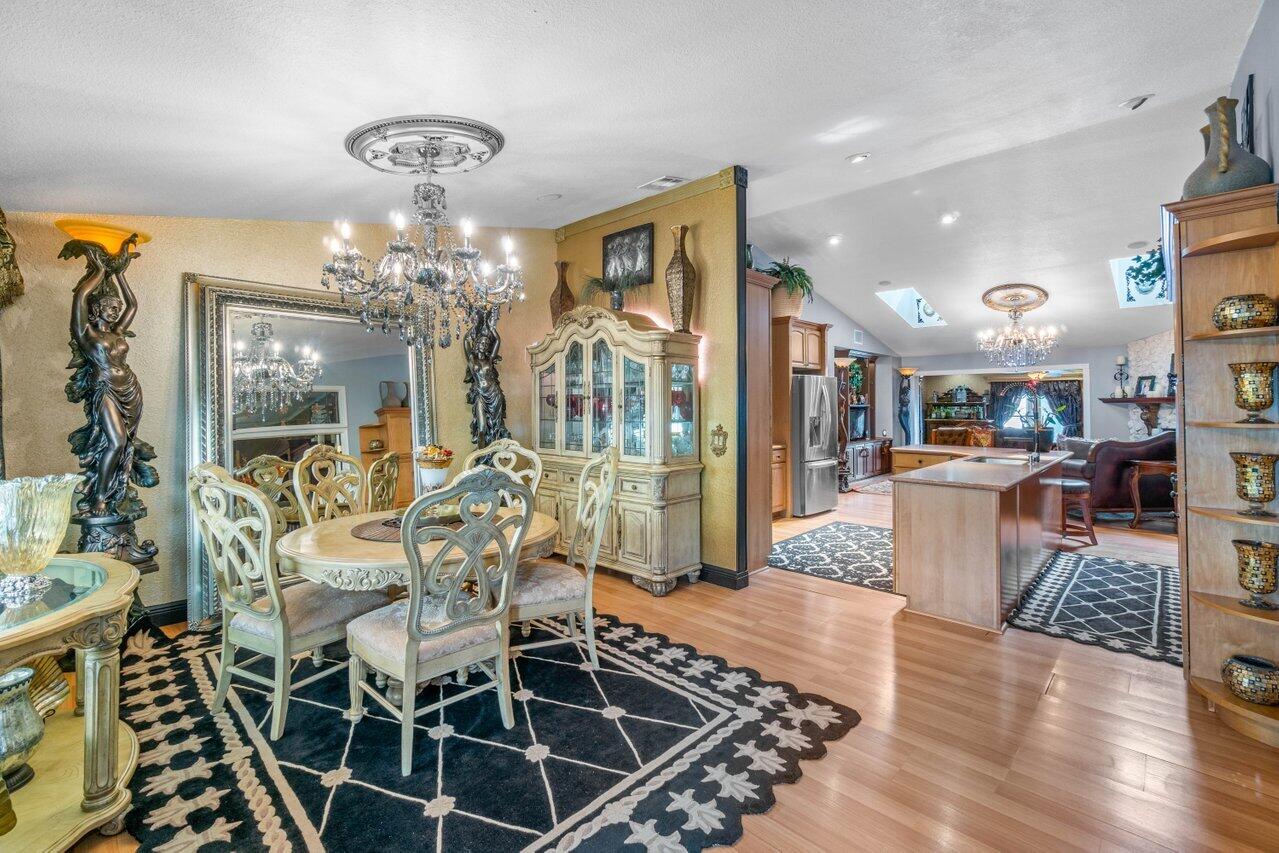 294 Northwest 69th Street Boca Raton, FL 33487 - Photo 6 of 39 a view of a dining room with furniture wooden floor and chandelier