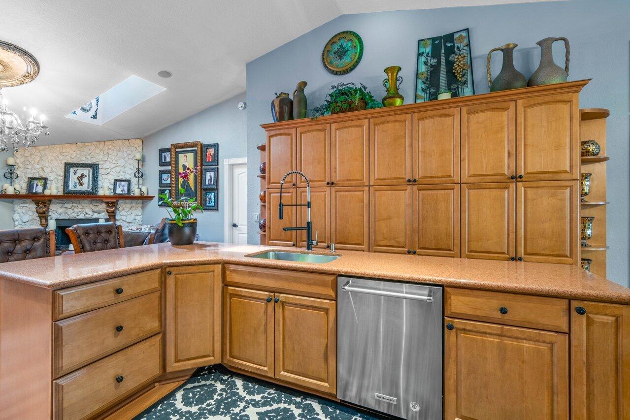 294 Northwest 69th Street Boca Raton, FL 33487 - Photo 9 of 39 a kitchen with stainless steel appliances granite countertop a sink and cabinets