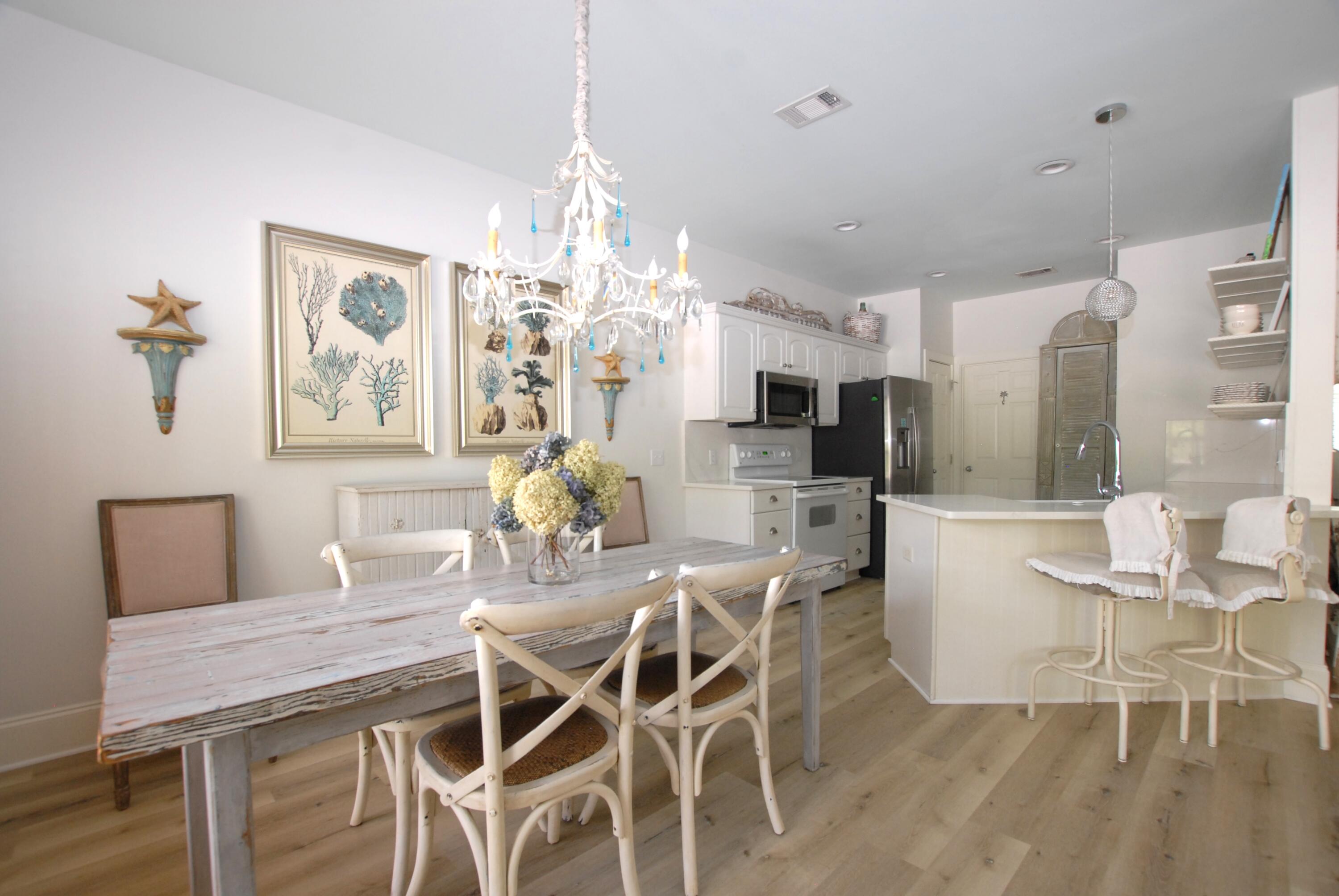 16 Kingfish Street Santa Rosa Beach, FL 32459 - Photo 7 of 21 a view of a dining room with furniture a chandelier and wooden floor