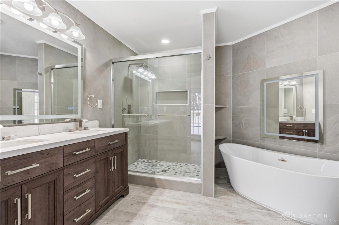 3190 Rebert Pike Springfield, OH 45502 - Photo 25 of 48 This primary bathroom features dual vanities, a spacious walk-in shower, and a luxurious soaking tub.