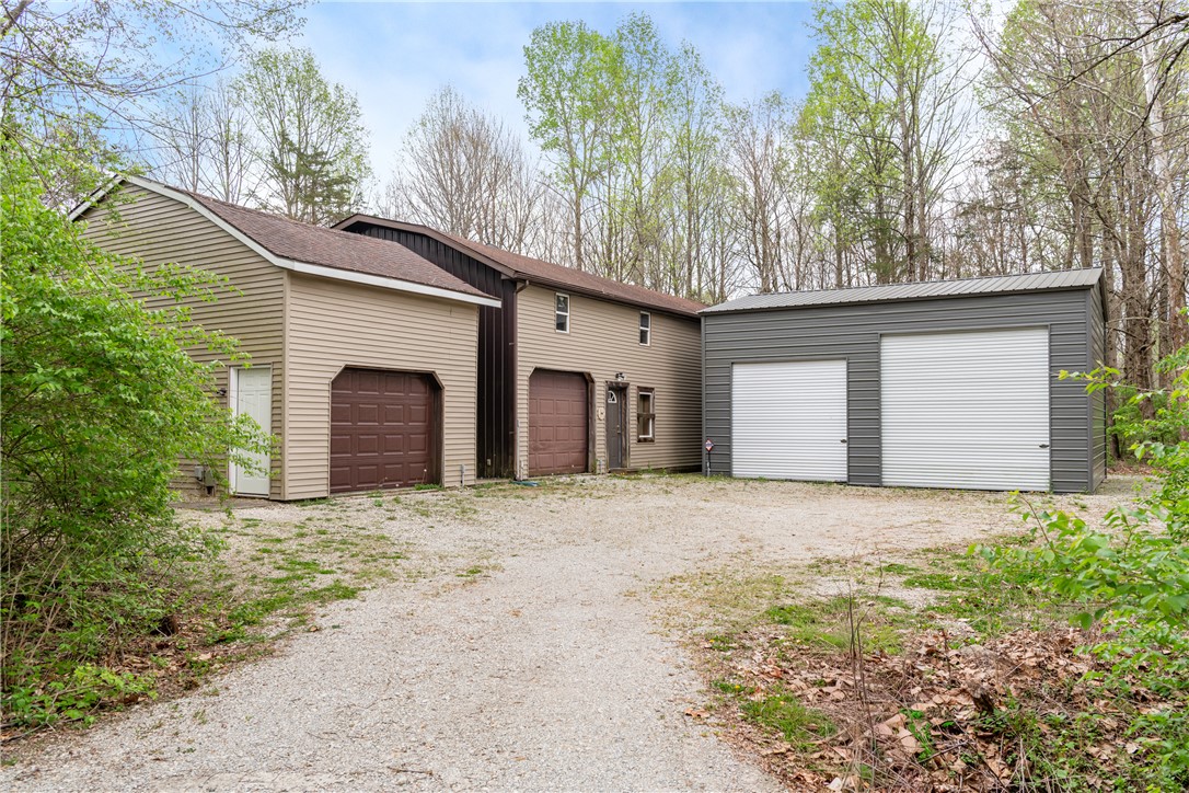 6750 Little Twin Road Germantown, OH 45327 - Photo 47 of 88 This property features multiple garage spaces and a practical exterior with a gravel driveway.