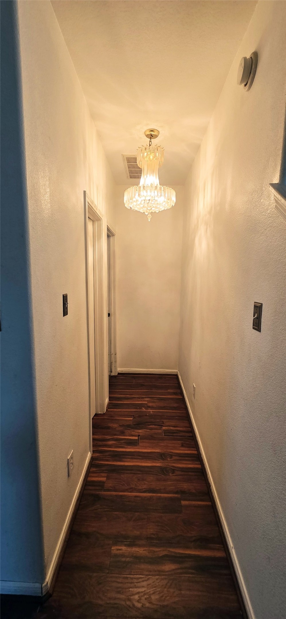 23526 Whispering Maple Drive Spring, TX 77373 - Photo 11 of 23 a view of a hallway with wooden floor and a chandelier