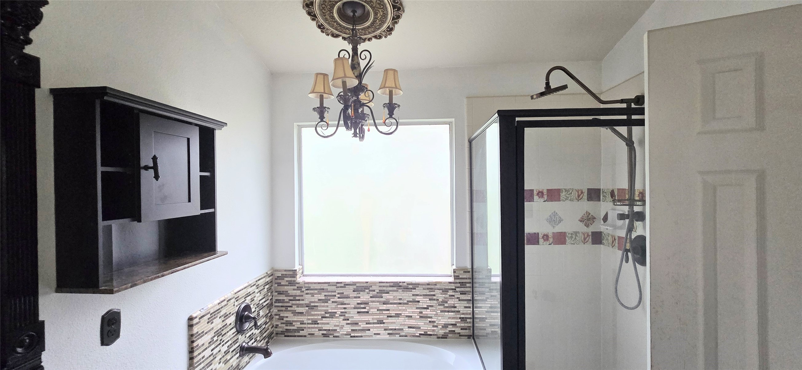 23526 Whispering Maple Drive Spring, TX 77373 - Photo 21 of 23 a bedroom with a bed and a chandelier