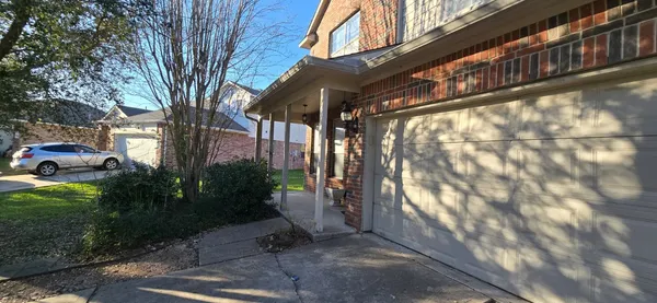 a pathway of a house with a yard