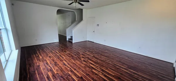 wooden floor in an empty room with a window
