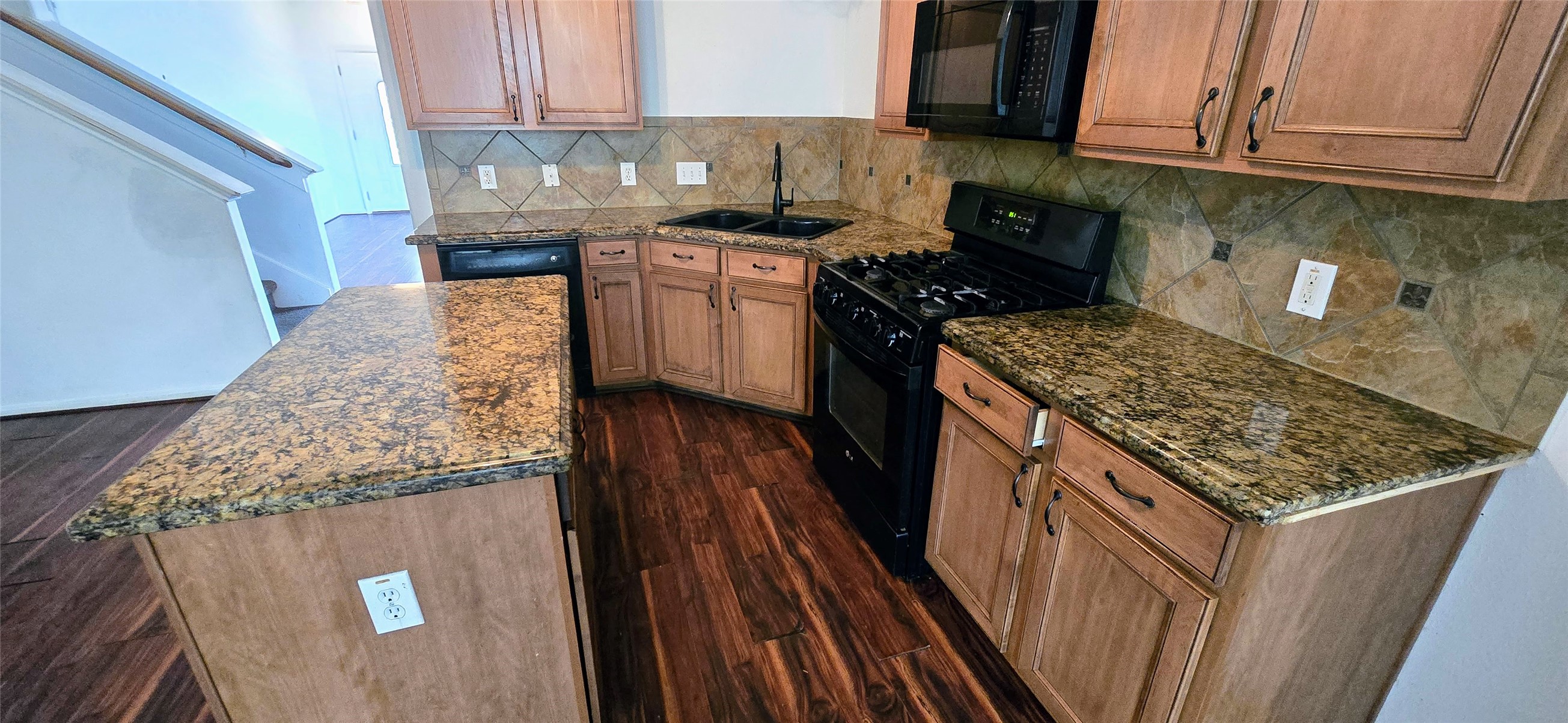 23526 Whispering Maple Drive Spring, TX 77373 - Photo 10 of 23 a kitchen with stainless steel appliances granite countertop a stove a sink and a microwave