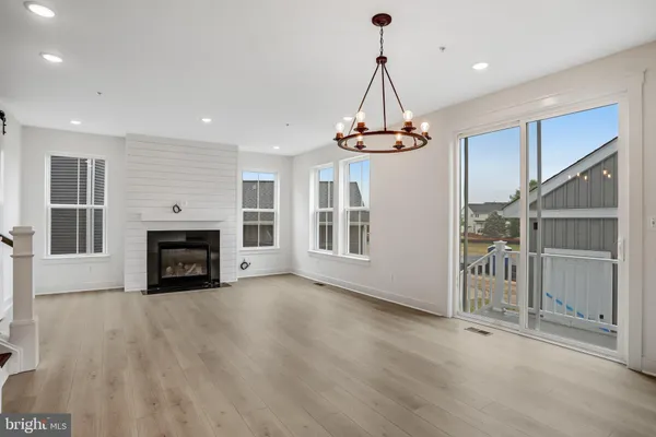 a view of kitchen with sink and refrigerator