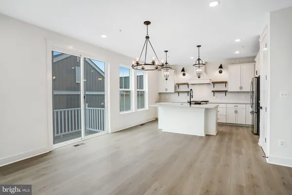 a kitchen with stainless steel appliances granite countertop a stove a refrigerator and a sink