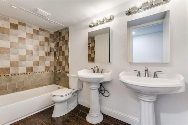a bathroom with a sink toilet and shower