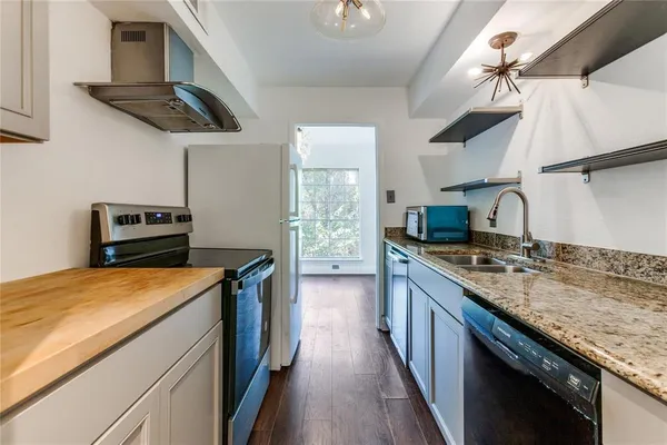 a kitchen with stainless steel appliances granite countertop a stove and a sink