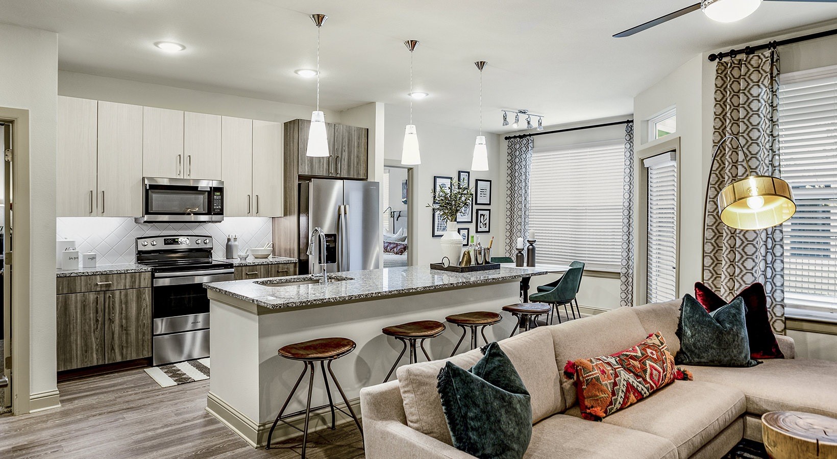 7100 Uvalde Road, Unit 3308 Houston, TX 77049 - Photo 13 of 28 a kitchen with stainless steel appliances granite countertop a stove a refrigerator a sink a dining table and chairs