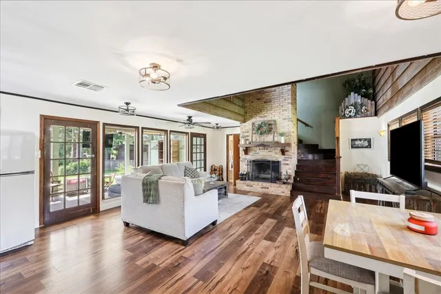 a living room with fireplace furniture and a flat screen tv