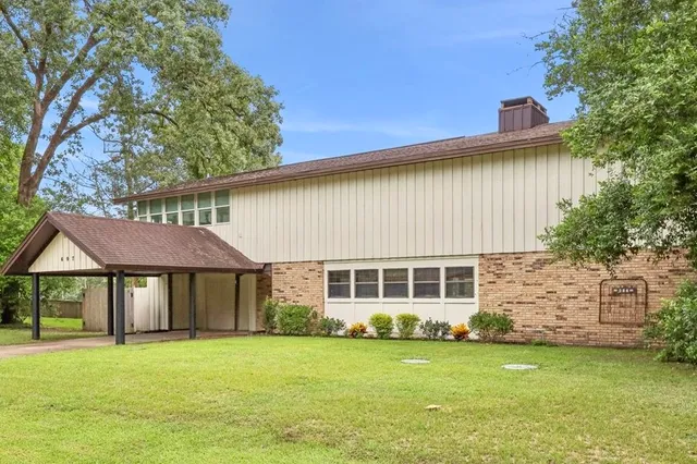 a front view of a house with a garden