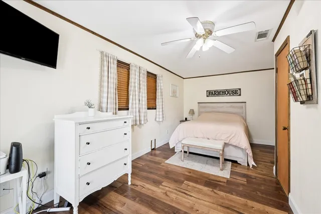 a spacious bedroom with a bed and a chandelier