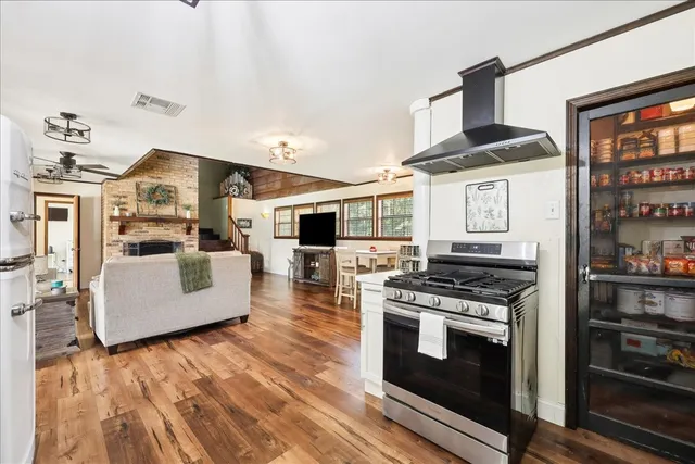 a kitchen with stainless steel appliances granite countertop a stove and a refrigerator