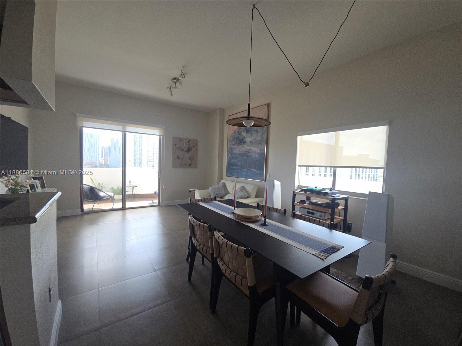 36 Northwest 6th Avenue, Unit TS9 Miami, FL 33128 - Photo 12 of 50 a view of a dining room with furniture window and wooden floor