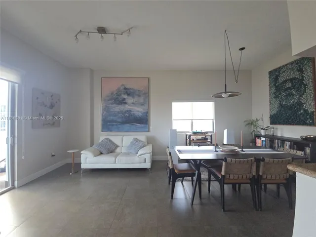 a kitchen with stainless steel appliances granite countertop a refrigerator a stove and a sink