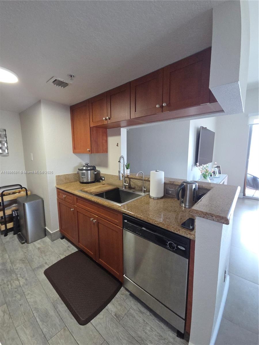 36 Northwest 6th Avenue, Unit TS9 Miami, FL 33128 - Photo 17 of 50 a kitchen with stainless steel appliances granite countertop a sink stove and cabinets