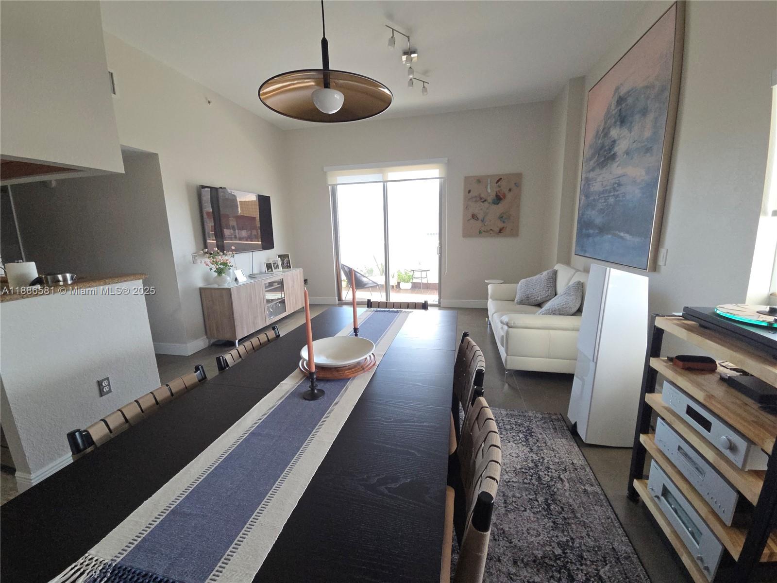 36 Northwest 6th Avenue, Unit TS9 Miami, FL 33128 - Photo 20 of 50 a living room with furniture and a flat screen tv